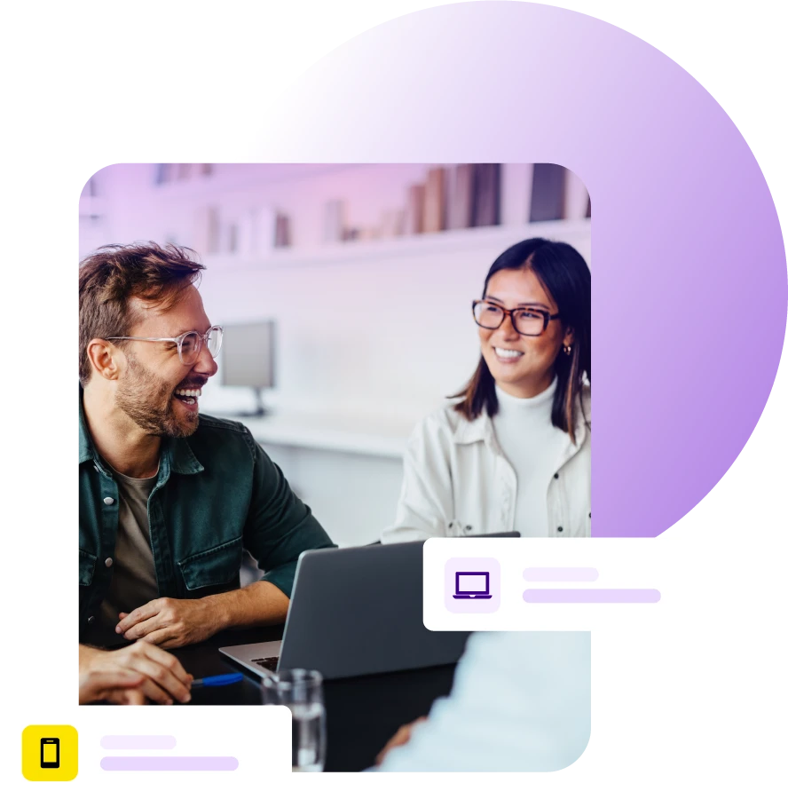 Man and lady smiling during a meeting with laptop on table